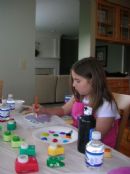 Shelby painting her pottery Shelby painting her pottery